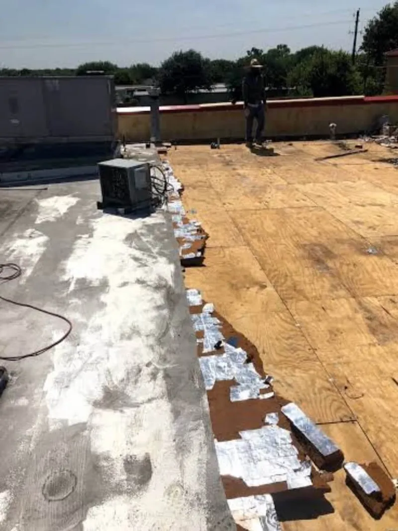Installing clean galvanized edge metal flashing along a low-slope roof parapet