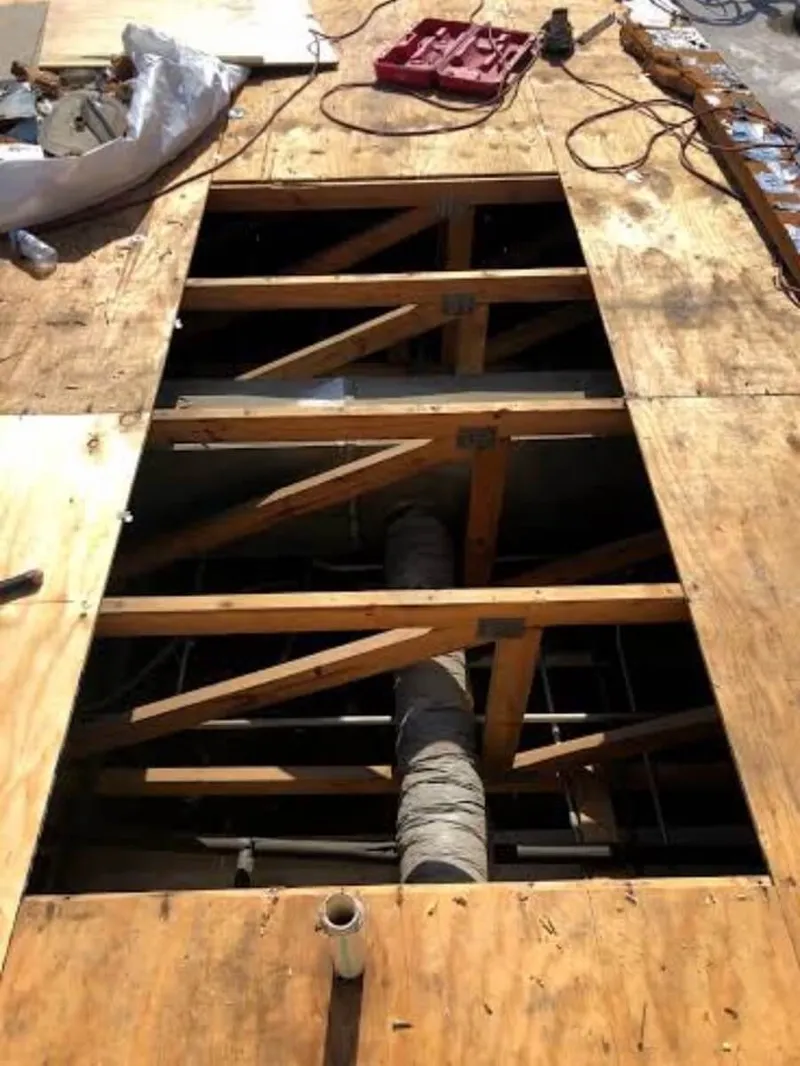 Reinforcing waterproof seals around a large commercial HVAC system curb mount