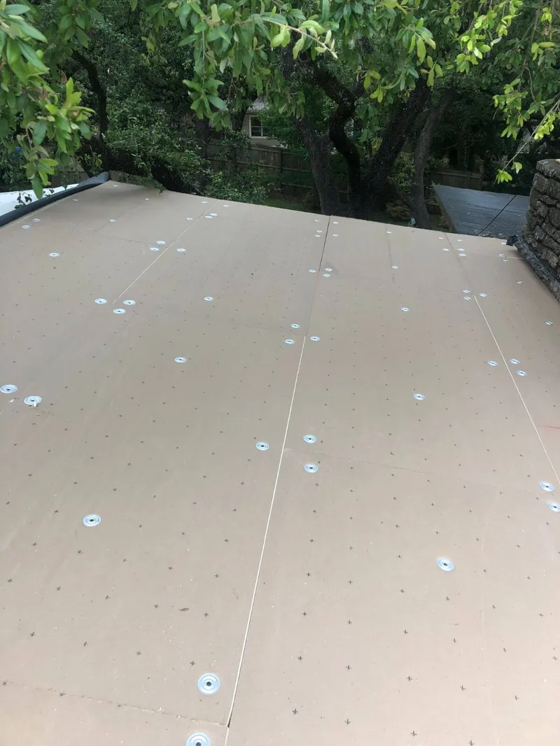 Close-up of clean pre-finished edge metal trim installed on a commercial building roof corner